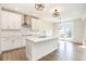 Spacious kitchen featuring stainless steel appliances, quartz countertops, and a center island with a sink at 25 Running Terrace Way, Cartersville, GA 30121
