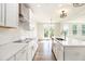 Modern white kitchen with stainless steel appliances, quartz countertops, and center island sink at 25 Running Terrace Way, Cartersville, GA 30121