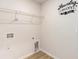 Laundry room with wood-look vinyl flooring, utility connections, and an overhead wire storage rack at 25 Running Terrace Way, Cartersville, GA 30121