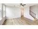 Bright living room featuring hardwood floors, a ceiling fan, and staircase with wood and iron at 25 Running Terrace Way, Cartersville, GA 30121