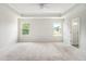 Spacious main bedroom featuring carpet flooring, tray ceiling, a ceiling fan and natural light at 25 Running Terrace Way, Cartersville, GA 30121