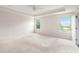 Bright main bedroom featuring carpet flooring, tray ceiling, and natural light from the window at 25 Running Terrace Way, Cartersville, GA 30121