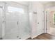 Stylish glass shower with subway tile, a built-in seat, and linen storage with view to bedroom at 25 Running Terrace Way, Cartersville, GA 30121