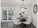 Bright dining area with a modern light fixture, stylish decor, and views of the backyard through glass doors at 5421 Brownlee Rd, Stone Mountain, GA 30087