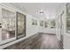Bright sunroom with brick wall, tile floor, and large windows at 5421 Brownlee Rd, Stone Mountain, GA 30087