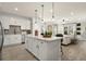 Spacious open-concept kitchen with white cabinetry, stainless steel appliances, and a large center island with seating at 208 Bastian Dr # 108, Villa Rica, GA 30180