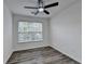 Bedroom featuring a window and wood look laminate flooring at 2803 Snapfinger Manor Mnr, Decatur, GA 30035