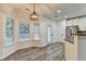 Dining area with wood-look floors, decorative light fixture, and adjacent kitchen at 2803 Snapfinger Manor Mnr, Decatur, GA 30035