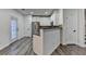 Open kitchen area features a breakfast bar, stainless steel appliances, and wood-style floors at 2803 Snapfinger Manor Mnr, Decatur, GA 30035