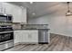 Open kitchen with stainless steel appliances, breakfast bar, granite counters, and wood-style flooring at 2803 Snapfinger Manor Mnr, Decatur, GA 30035