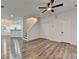 Bright living room with stairs, neutral walls, modern ceiling fan, and stylish wood-look flooring at 2803 Snapfinger Manor Mnr, Decatur, GA 30035