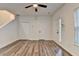 Bright living room featuring modern ceiling fan, two closets, neutral walls, and stylish wood-look flooring at 2803 Snapfinger Manor Mnr, Decatur, GA 30035