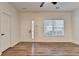 Bright living room with neutral walls, modern ceiling fan, and wood-look flooring at 2803 Snapfinger Manor Mnr, Decatur, GA 30035