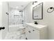 Modern bathroom featuring white marble tile, sleek black fixtures, and contemporary design at 38 Creek Se Dr, Cartersville, GA 30121