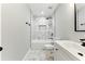 Modern bathroom featuring marble tile, tub-shower combo with black fixtures, and a white vanity with sink at 38 Creek Se Dr, Cartersville, GA 30121