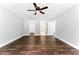 Spacious bedroom featuring hardwood floors, a ceiling fan, and a view to an ensuite bath at 38 Creek Se Dr, Cartersville, GA 30121