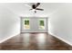Large bedroom with hardwood floors, ceiling fan, and two large windows at 38 Creek Se Dr, Cartersville, GA 30121