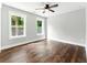 Spacious bedroom with hardwood floors, ceiling fan, and two large windows at 38 Creek Se Dr, Cartersville, GA 30121