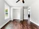 Bright bedroom featuring hardwood floors, a ceiling fan, and a closet with open doors at 38 Creek Se Dr, Cartersville, GA 30121