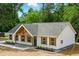 A cozy one-story home featuring charming wood accents and landscaping, complete with a gray shingle roof at 38 Creek Se Dr, Cartersville, GA 30121