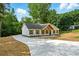 Charming single-story home with white siding, complemented by a neatly paved driveway and landscaped yard at 38 Creek Se Dr, Cartersville, GA 30121