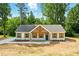 Charming home with a blue front door and wooden shuttered windows framed by lush greenery at 38 Creek Se Dr, Cartersville, GA 30121