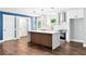 Bright and airy kitchen featuring a central island, stainless steel range hood, and modern pendant lighting at 38 Creek Se Dr, Cartersville, GA 30121