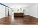 Open-concept space with warm wood floors and a modern kitchen island with white countertop and wood accents at 38 Creek Se Dr, Cartersville, GA 30121