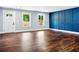 Spacious living area with a large window for natural light and a stylish blue accent wall with paneling at 38 Creek Se Dr, Cartersville, GA 30121