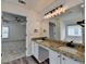 Primary bathroom featuring double sinks, a large mirror, a walk-in shower and bathtub at 7196 Toccoa Circle, Union City, GA 30291