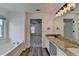 Primary bathroom featuring double sinks, a large mirror, a walk-in shower and bathtub at 7196 Toccoa Circle, Union City, GA 30291