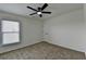 Bright bedroom with carpet flooring, fresh paint and a ceiling fan, complemented by a window and a door at 7196 Toccoa Circle, Union City, GA 30291