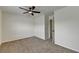 A standard bedroom with neutral carpeting, walls, and a ceiling fan with an attached light fixture at 7196 Toccoa Circle, Union City, GA 30291