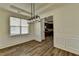 Dining room displaying modern lighting and molding, transitioning into the kitchen at 7196 Toccoa Circle, Union City, GA 30291