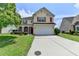 Two-story home with red shutters, manicured lawn, and a long driveway at 7196 Toccoa Circle, Union City, GA 30291
