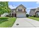Two-story home with red shutters, manicured lawn, and a long driveway at 7196 Toccoa Circle, Union City, GA 30291