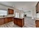 Kitchen featuring wood cabinets, granite countertops, stainless steel appliances, and a center island at 7196 Toccoa Circle, Union City, GA 30291