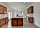 Kitchen featuring wood cabinets, granite countertops, stainless steel appliances, and a center island at 7196 Toccoa Circle, Union City, GA 30291