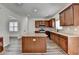 Modern kitchen featuring an island, stainless steel appliances, wood cabinets, and granite countertops at 7196 Toccoa Circle, Union City, GA 30291