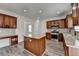 Kitchen featuring wood cabinets, granite countertops, stainless steel appliances, and a center island at 7196 Toccoa Circle, Union City, GA 30291