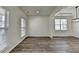 Open-concept living area featuring decorative moulding, wood grain floors and stylish lighting at 7196 Toccoa Circle, Union City, GA 30291