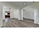 Open-concept living and dining area featuring hardwood floors, molding, and modern lighting fixture at 7196 Toccoa Circle, Union City, GA 30291