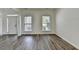 Living room featuring decorative moulding, wood grain floors and sunlit windows at 7196 Toccoa Circle, Union City, GA 30291