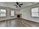 Bright living room with a ceiling fan, fireplace, and hardwood floors at 7196 Toccoa Circle, Union City, GA 30291