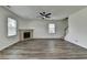 Living room with hardwood floors, a fireplace, ceiling fan, and lots of natural light at 7196 Toccoa Circle, Union City, GA 30291