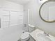 Clean bathroom featuring a tub and shower combo with white tile and a vanity with a round mirror at 978 Monopoly Dr, Lawrenceville, GA 30046