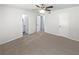 Bright and airy bedroom featuring neutral carpet, a ceiling fan, and ample closet space, ready for personalization at 978 Monopoly Dr, Lawrenceville, GA 30046