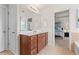Bathroom vanity with a large mirror and a glimpse into the bedroom at 2428 Hadlow Ln # 25, Atlanta, GA 30339