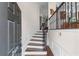 Inviting entryway features hardwood floors, elegant wainscoting, and a staircase with iron balusters at 2428 Hadlow Ln # 25, Atlanta, GA 30339