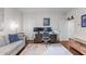 Bright home office area with two monitors, sofa, and light wood flooring at 2428 Hadlow Ln # 25, Atlanta, GA 30339
